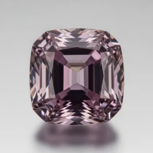 Close-up of a faceted, violet-colored Taaffeite gemstone, one of the rarest minerals on Earth
